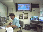 Checking official Manual, PTWC Director Chip McCreery prepares for Exercise Pacific Wave 08